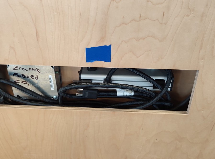 Cable access panel in desk casework with power and data cable managed inside