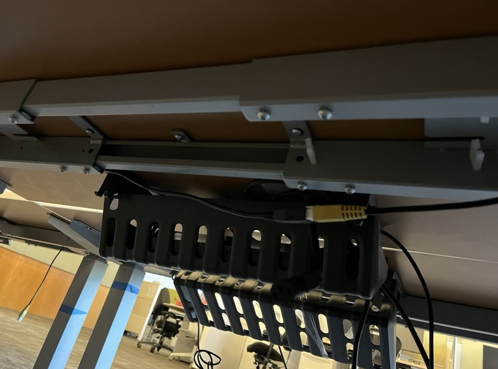 Under-desk cable basket installed by NCS with power and data cable routed through it